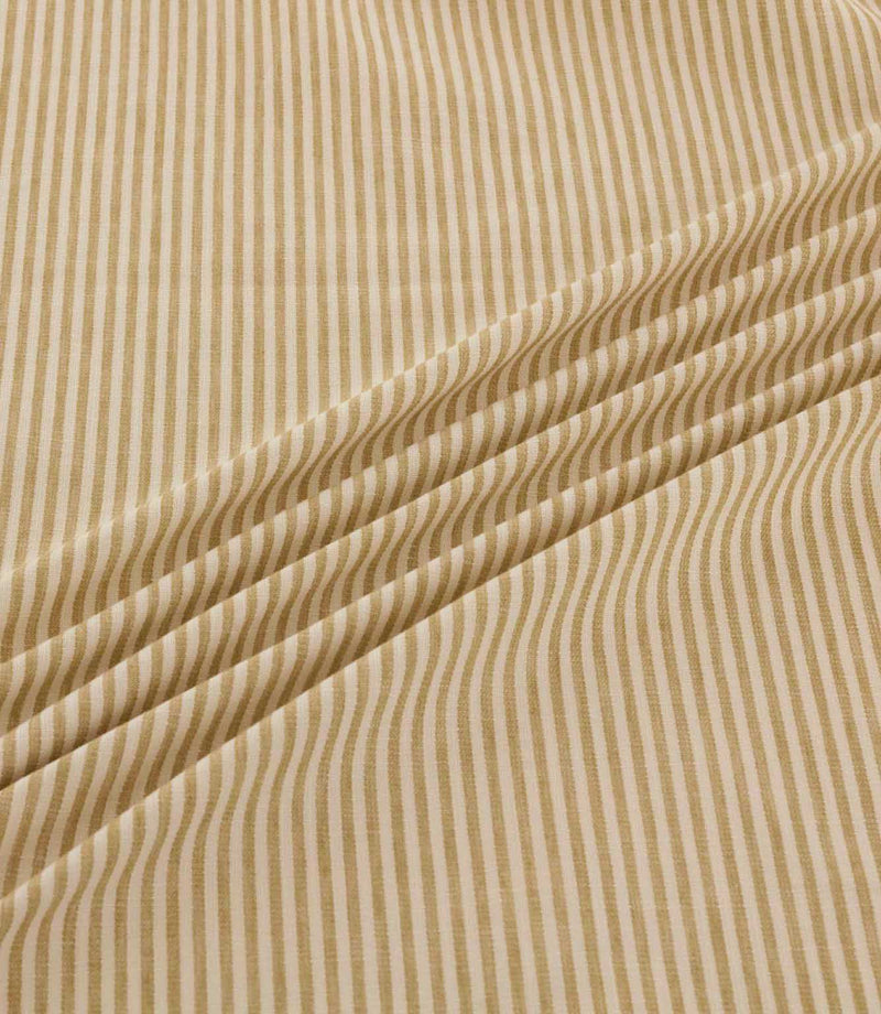 Shoreham Sandytan striped fabric arranged in soft diagonal folds, showcasing its warm sandy beige and cream ticking stripes, textured woven finish and natural drape.