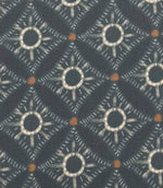 Close-up of Solstice Halo foliage-inspired outdoor fabric with abstract halo motifs in soft blue-grey, cream, and warm amber tones.