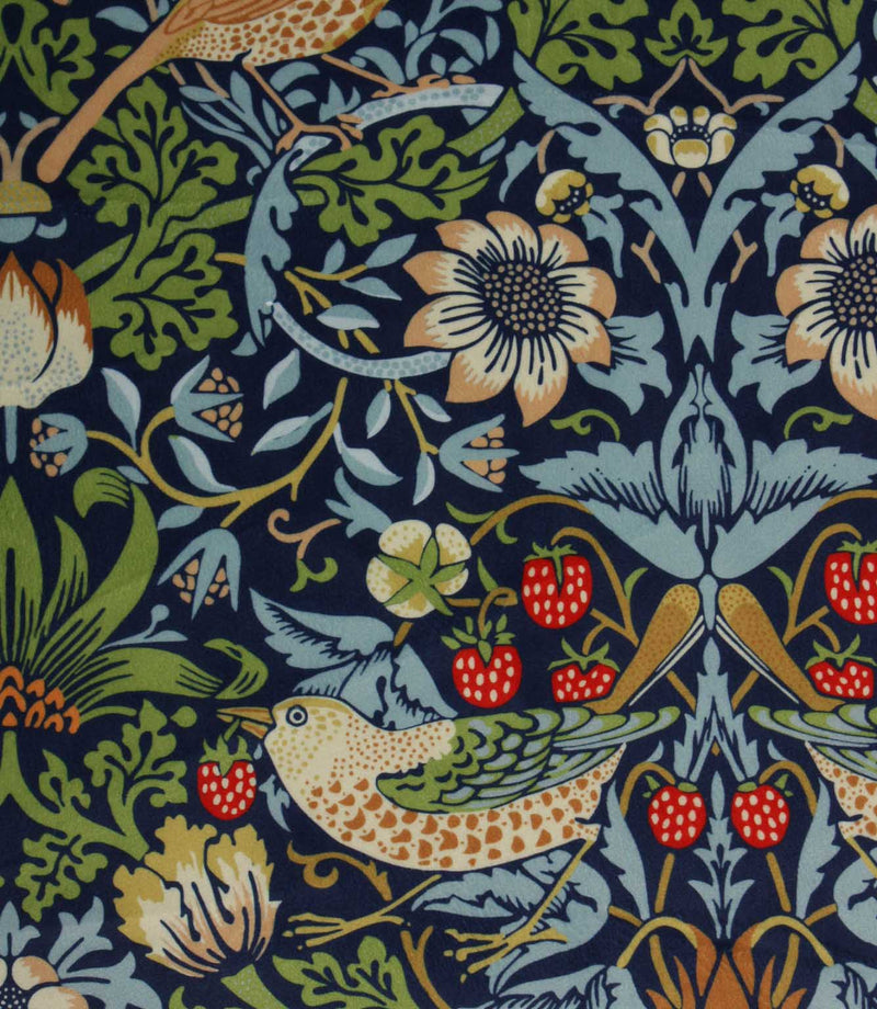 Patterned William Morris velvet fabric with birds, flowers, and berries on a dark blue background
