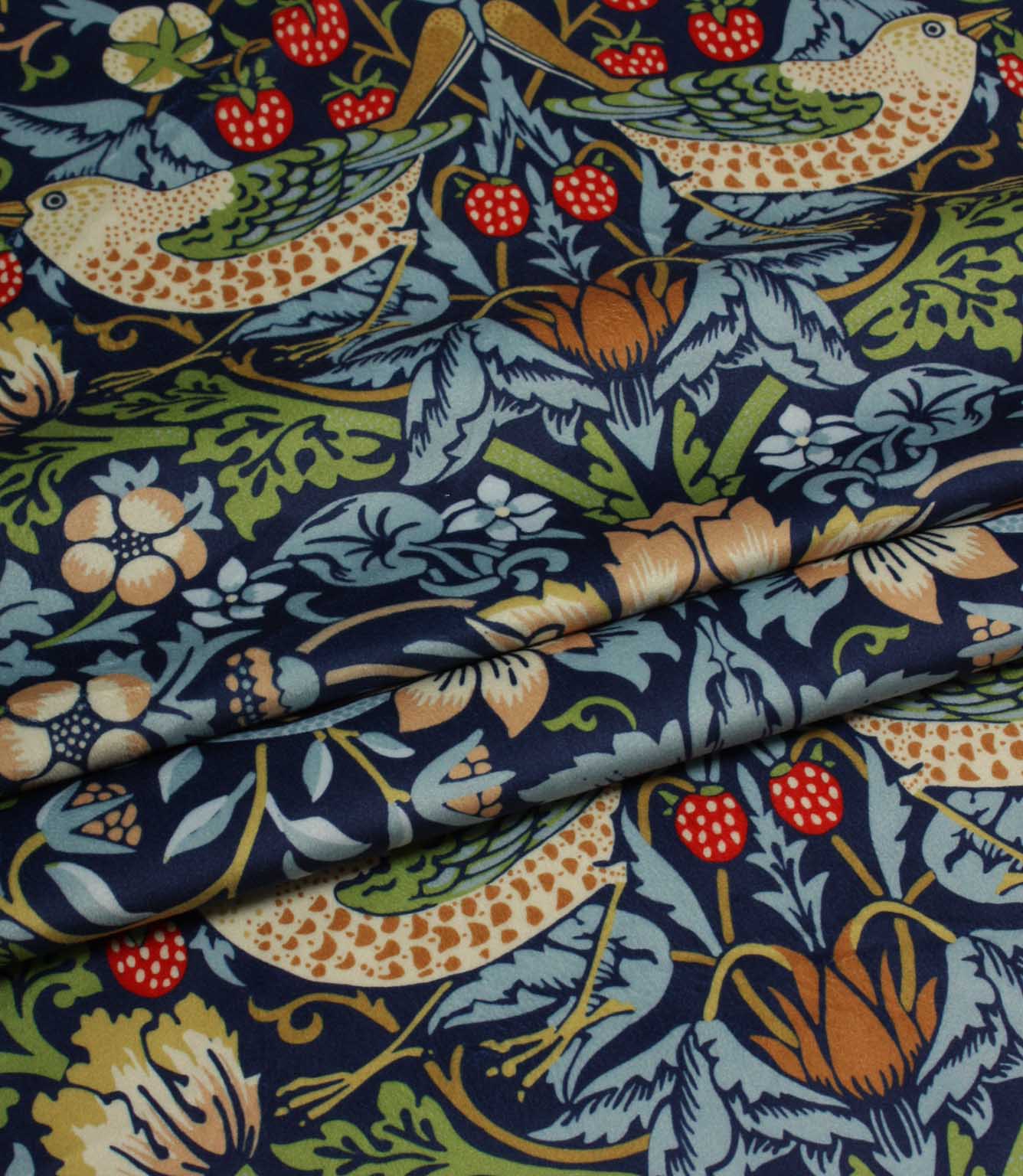 Patterned velvet William Morris fabric with birds, flowers, and strawberries on a blue background