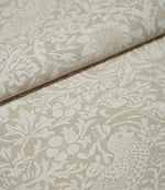 Folded Strawberry Thief Linen Look William Morris fabric in beige and off-white, highlighting the woven texture, bird motif, flowers and strawberries.