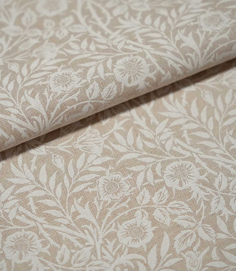 Folded cream and beige Sweet Briar Linen Look fabric, highlighting the woven texture and repeating botanical pattern of flowers and foliage.
