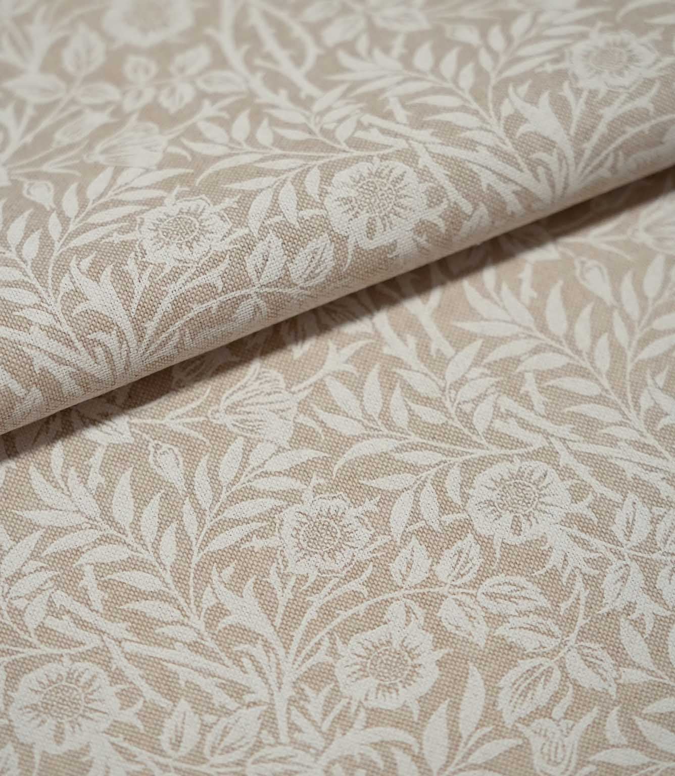 Folded cream and beige Sweet Briar Linen Look fabric, highlighting the woven texture and repeating botanical pattern of flowers and foliage.