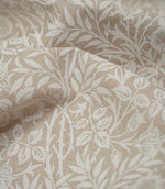 Close-up of cream and beige Sweet Briar Linen Look fabric, showing the detailed leaves, flowers and textured linen-look weave.