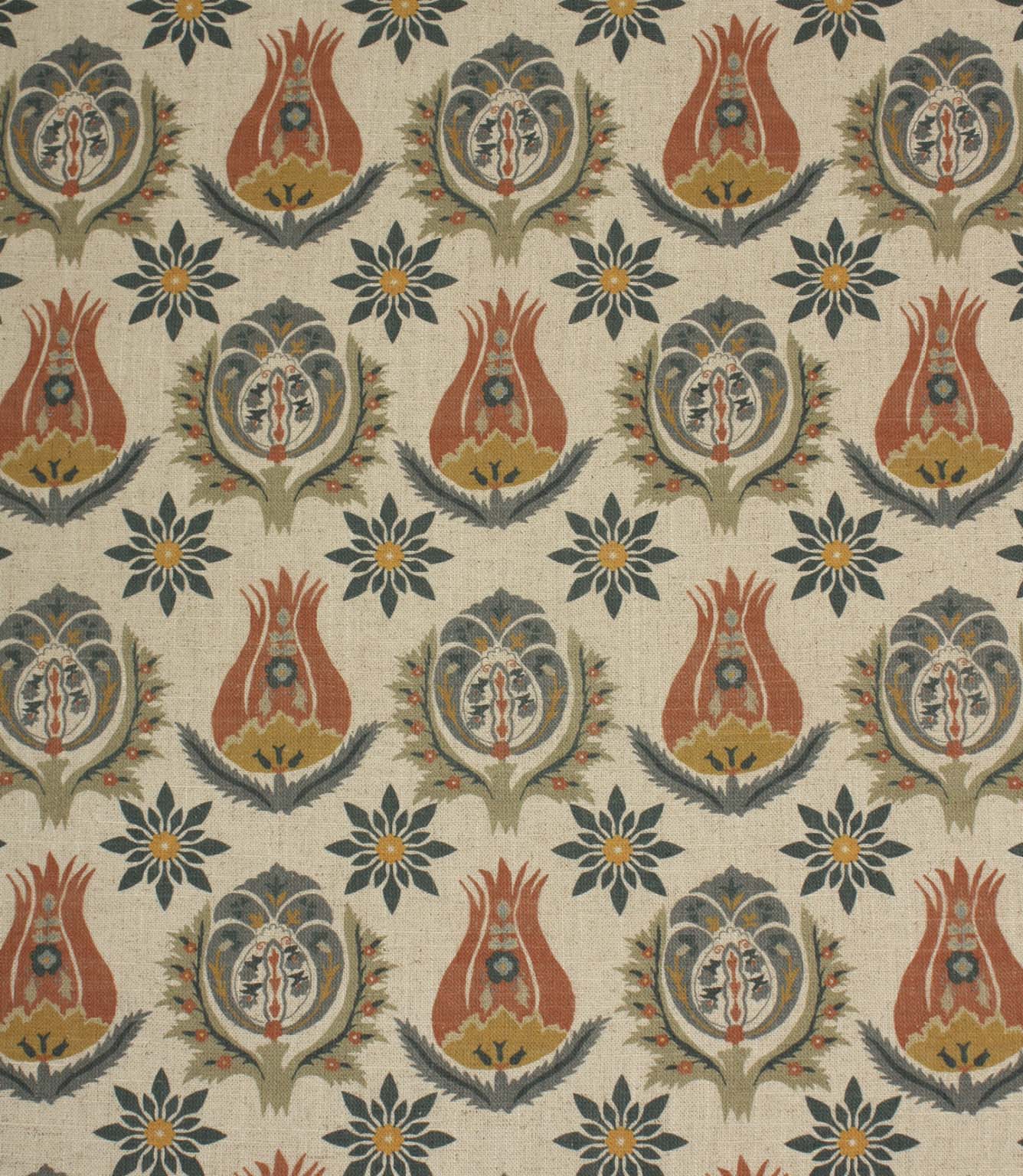 Linen-look fabric with repeating Arts and Crafts inspired floral motifs in terracotta, ochre and deep blue tones on a natural background.