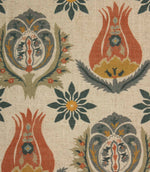 Close-up of decorative botanical fabric featuring stylised tulip motifs and floral medallions in rust red, slate blue and mustard shades.
