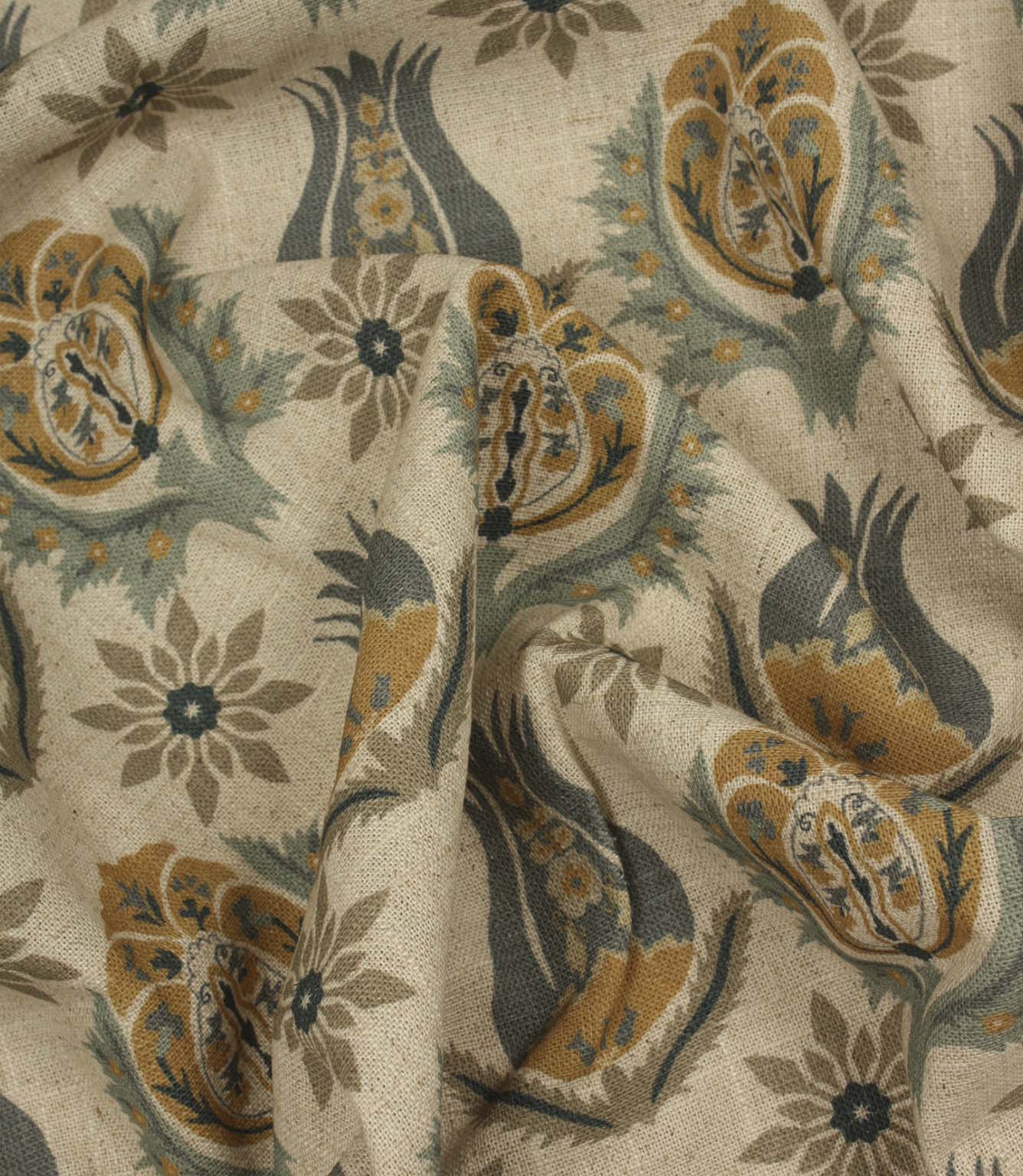 Draped botanical print fabric with stylised floral motifs in soft blue, mustard and natural linen shades.