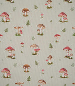 Toadstool Meadow Multi fabric featuring a repeating small-scale woodland print of red and brown mushrooms, spotted toadstools and delicate green fern sprigs on a natural beige woven background.