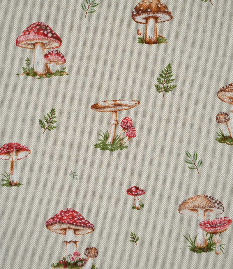 Close-up of Toadstool Meadow Multi fabric showing detailed red toadstools with white spots, brown woodland mushrooms and scattered green foliage on a textured natural beige background.