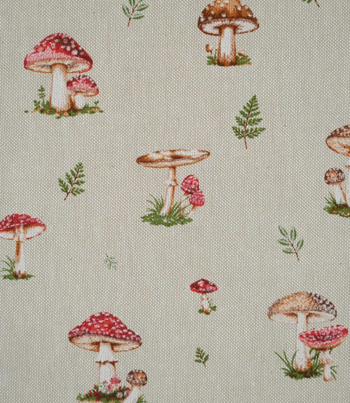 Close-up of Toadstool Meadow Multi fabric showing detailed red toadstools with white spots, brown woodland mushrooms and scattered green foliage on a textured natural beige background.
