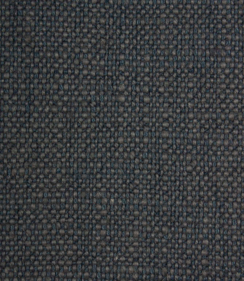 Close-up detail of Trento woven plain fabric in indigo, highlighting the rich texture and durable woven construction.