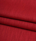 Folded Trento woven fabric in peony, displaying the fabric's texture, structure and woven finish.