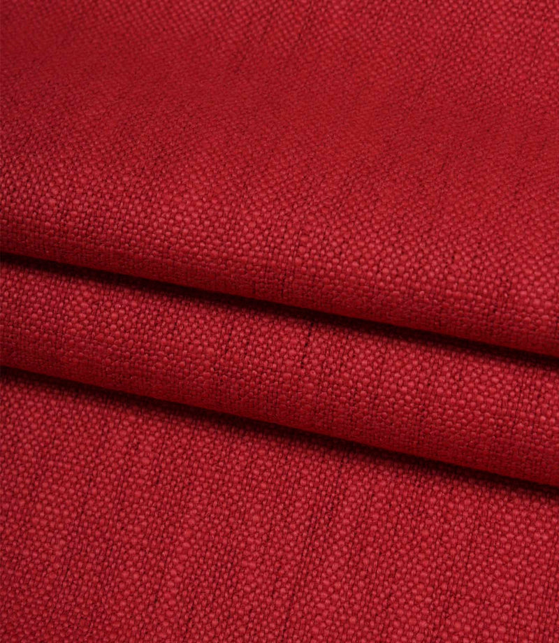 Folded Trento woven fabric in peony, displaying the fabric's texture, structure and woven finish.