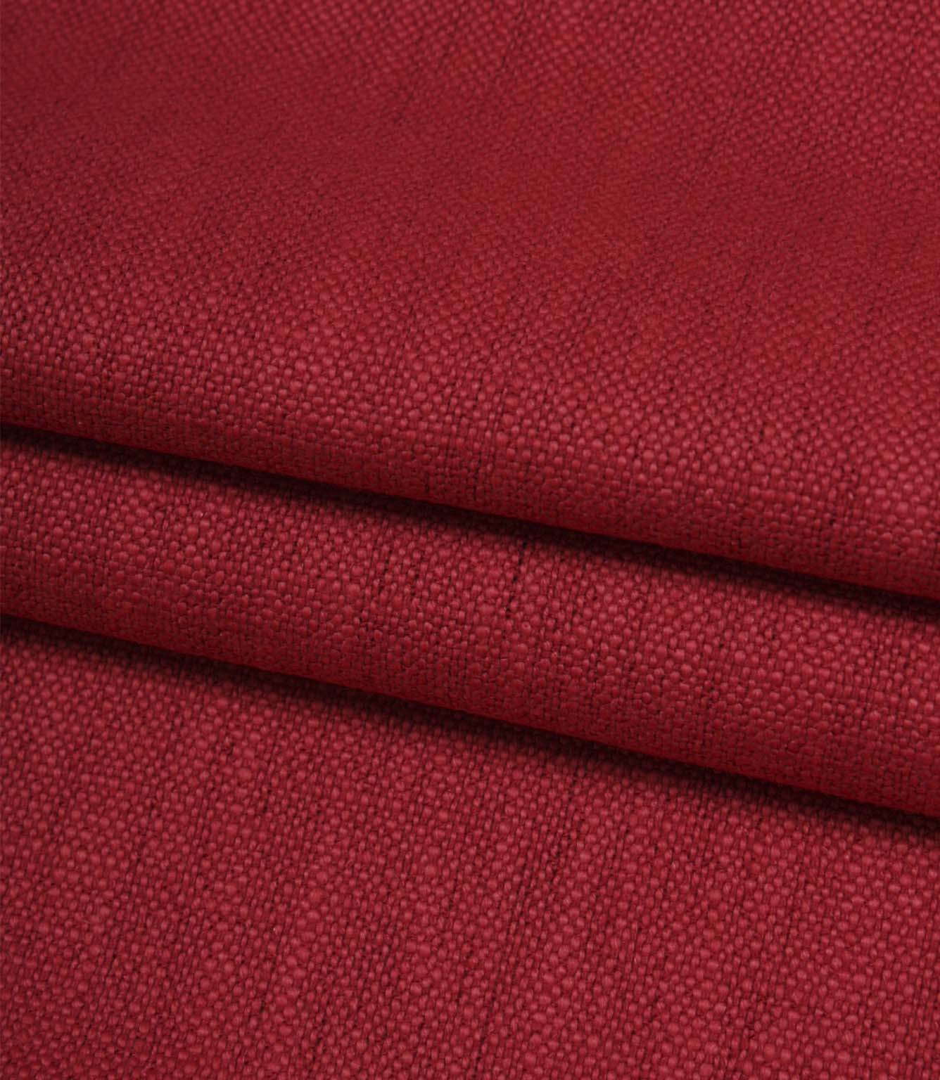 Folded Trento woven fabric in peony, displaying the fabric's texture, structure and woven finish.