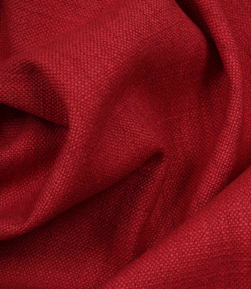 Trento woven fabric in peony draped in soft folds, illustrating its natural texture and suitability for curtains, blinds and cushions.