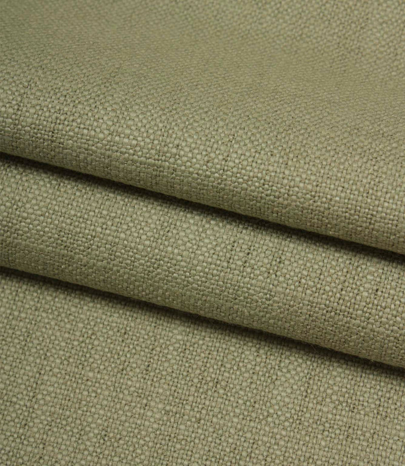Folded Trento woven plain fabric in sage, displaying the fabric's texture, weight and natural woven finish.
