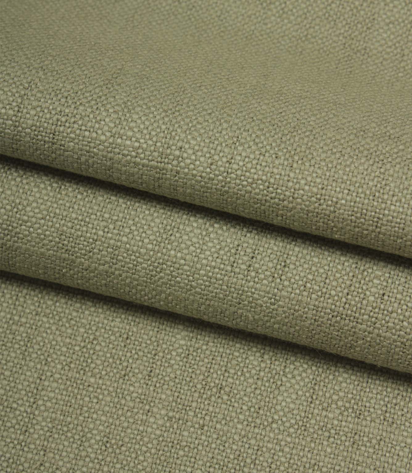 Folded Trento woven plain fabric in sage, displaying the fabric's texture, weight and natural woven finish.