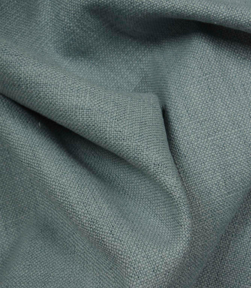 Trento woven fabric in sky draped in soft folds, illustrating its relaxed texture and suitability for curtains, blinds and cushions.