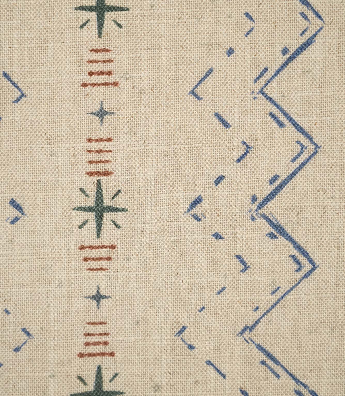 Close-up of Twilight Mill Blue Chestnut fabric showing the hand-drawn geometric motif with stitched zigzags and decorative star details.