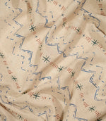 Twilight Mill Blue Chestnut fabric draped to demonstrate its soft handle and decorative small-scale geometric print.