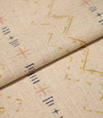 Folded Twilight Mill Gold fabric showcasing the textured woven finish and small-scale geometric pattern.