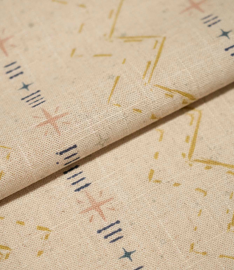 Folded Twilight Mill Gold fabric showcasing the textured woven finish and small-scale geometric pattern.