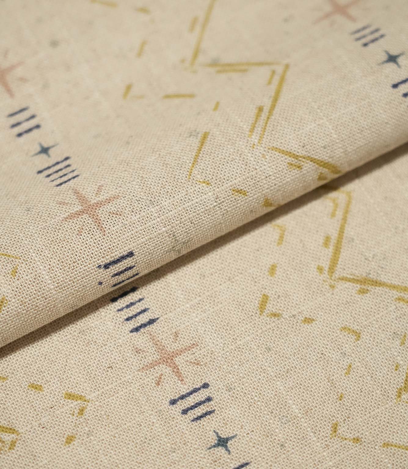 Folded Twilight Mill Gold fabric showcasing the textured woven finish and small-scale geometric pattern.