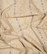 Twilight Mill Gold fabric draped to demonstrate its soft handle and decorative small-scale geometric print.