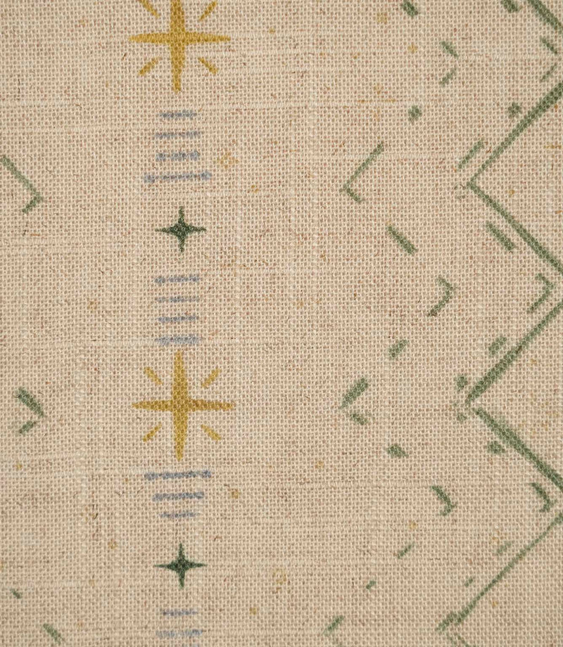 Close-up of Twilight Mill Green Apple Gold fabric showing the hand-drawn geometric motif with green zigzags, gold stars and fine blue stripe details.
