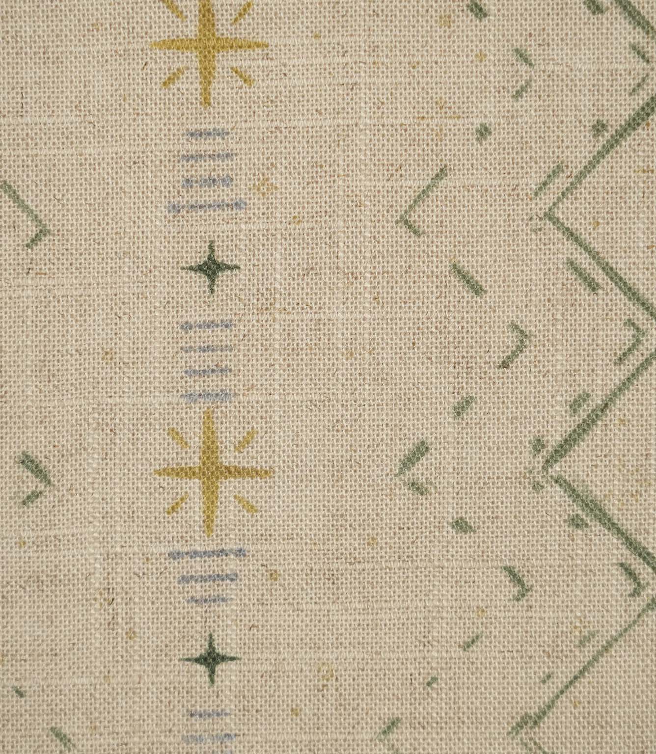 Close-up of Twilight Mill Green Apple Gold fabric showing the hand-drawn geometric motif with green zigzags, gold stars and fine blue stripe details.