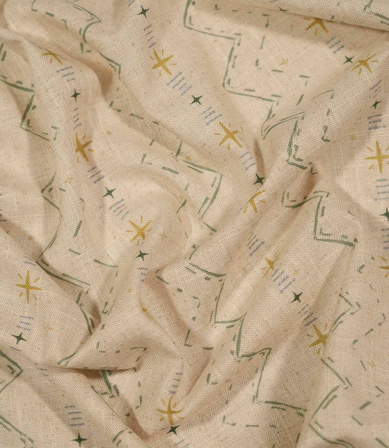 Twilight Mill Green Apple Gold fabric draped to demonstrate its soft handle and decorative small-scale geometric print.