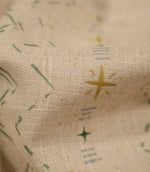 Macro close-up of Twilight Mill Green Apple Gold fabric highlighting the woven texture and hand-drawn geometric design.