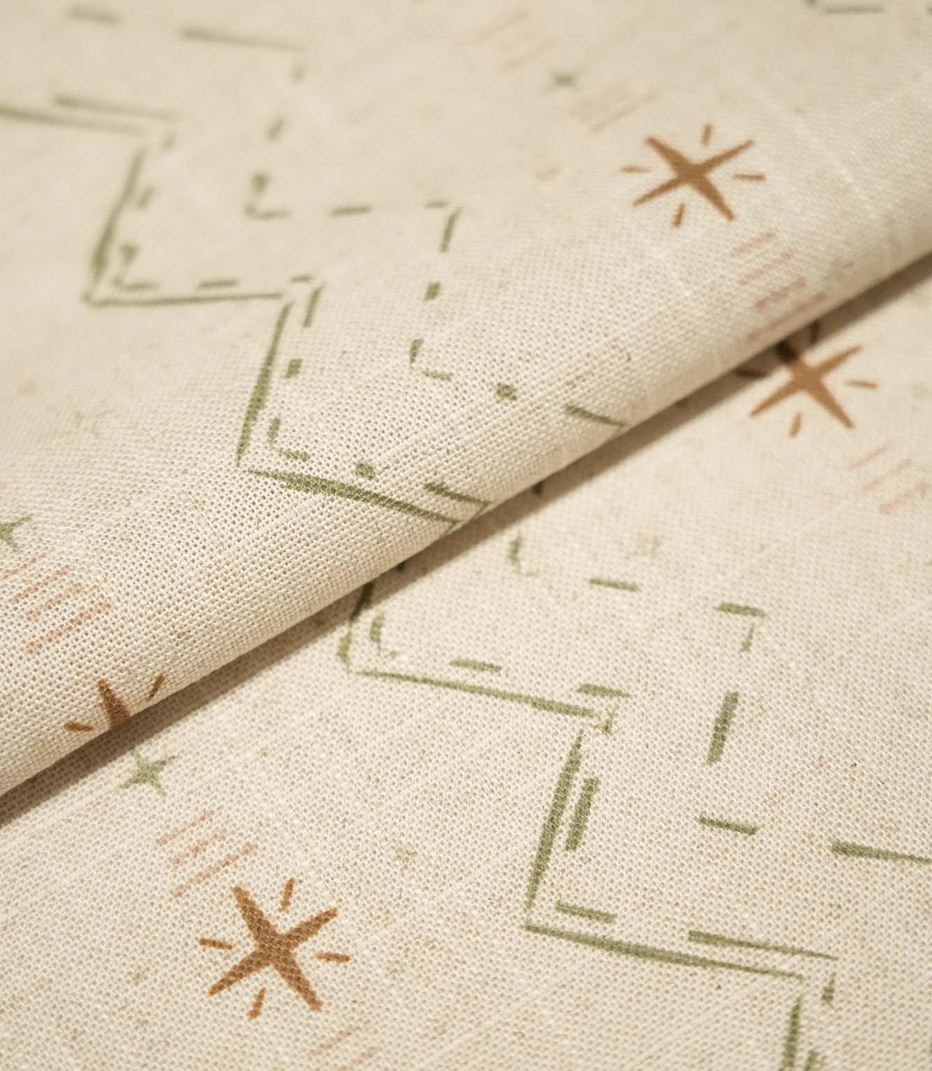 Folded Twilight Mill Olive Green Hazelnut fabric showcasing the textured woven finish and small-scale geometric pattern.