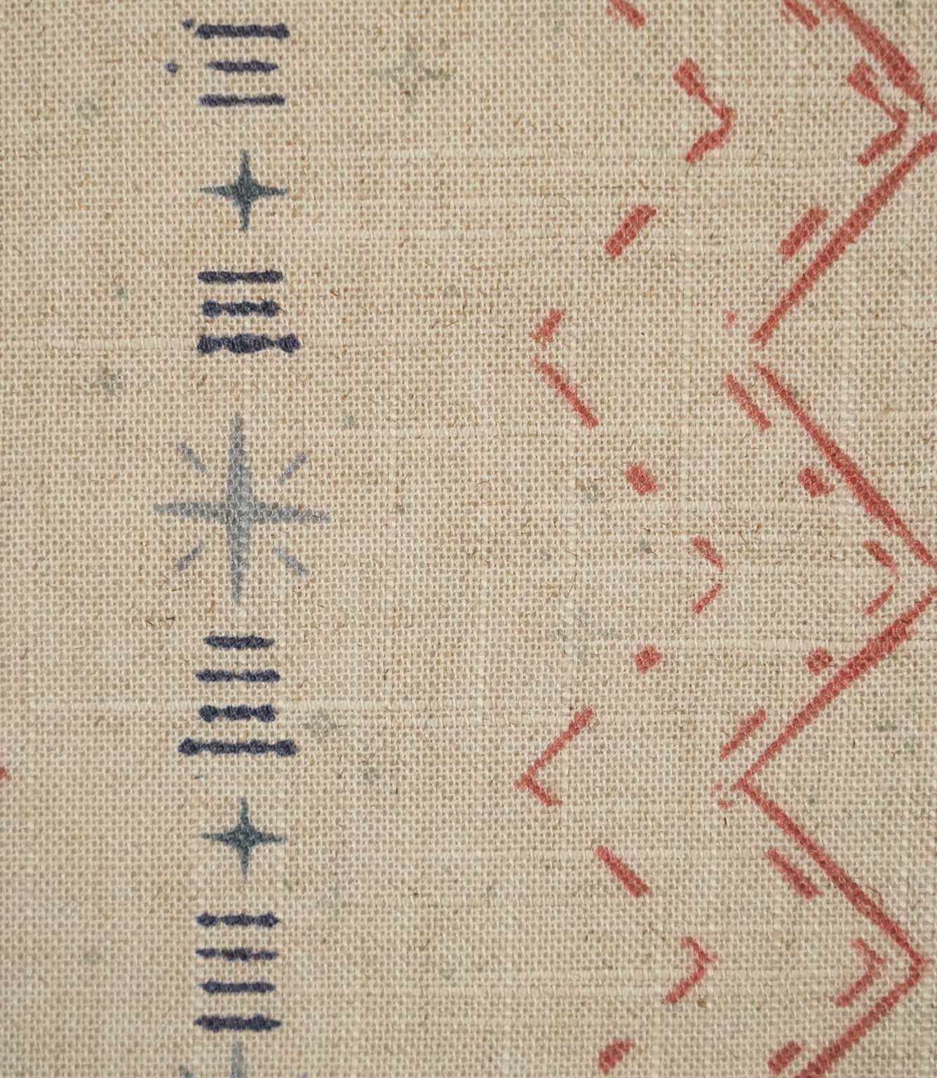 Close-up of Twilight Mill Red Steel Blue fabric showing the hand-drawn geometric motif with red zigzags, steel blue stars and linear accents.