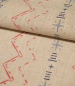 Folded Twilight Mill Red Steel Blue fabric showcasing the textured woven finish and repeating geometric pattern.