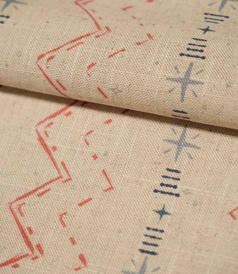 Folded Twilight Mill Red Steel Blue fabric showcasing the textured woven finish and repeating geometric pattern.