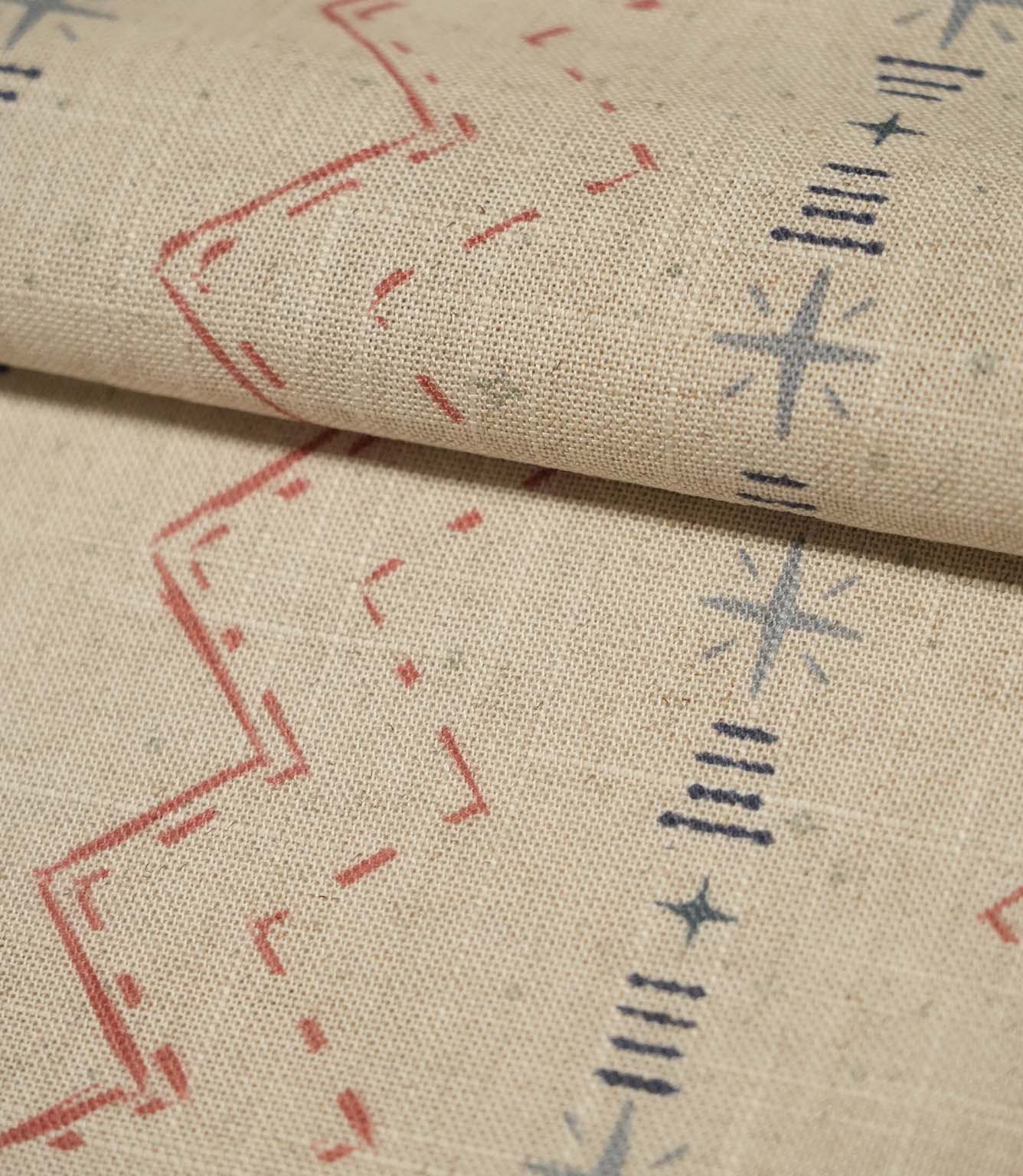 Folded Twilight Mill Red Steel Blue fabric showcasing the textured woven finish and repeating geometric pattern.