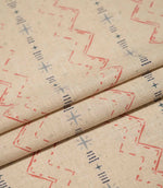 Layered Twilight Mill Red Steel Blue fabric displaying the small-scale geometric design and natural woven texture.