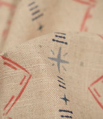 Macro close-up of Twilight Mill Red Steel Blue fabric highlighting the woven texture and hand-drawn geometric motif in red and steel blue.
