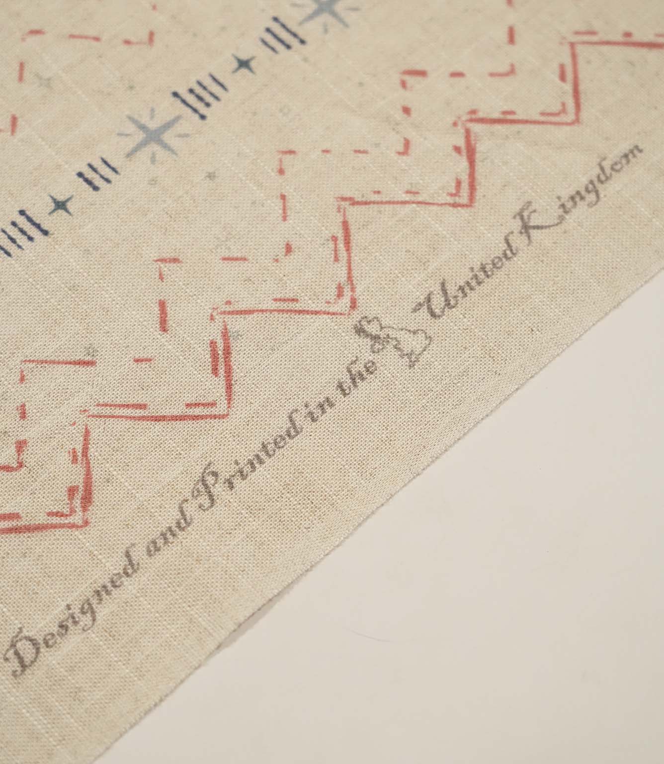 Twilight Mill Red Steel Blue fabric showing the printed geometric design alongside the branded fabric selvedge edge.