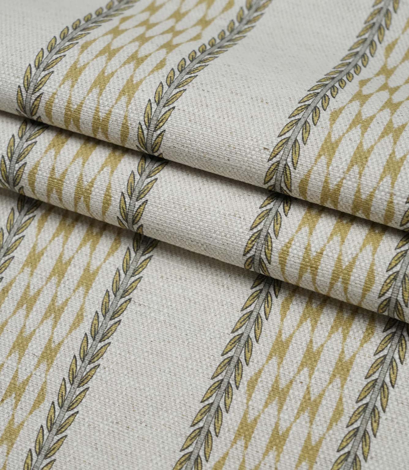 Folded Varese Gold extra wide fabric showing its woven finish and contemporary foliage stripe design.