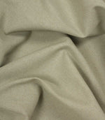 Close-up of beige woven fabric with folds