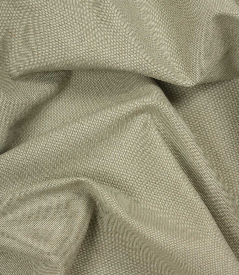 Close-up of beige woven fabric with folds