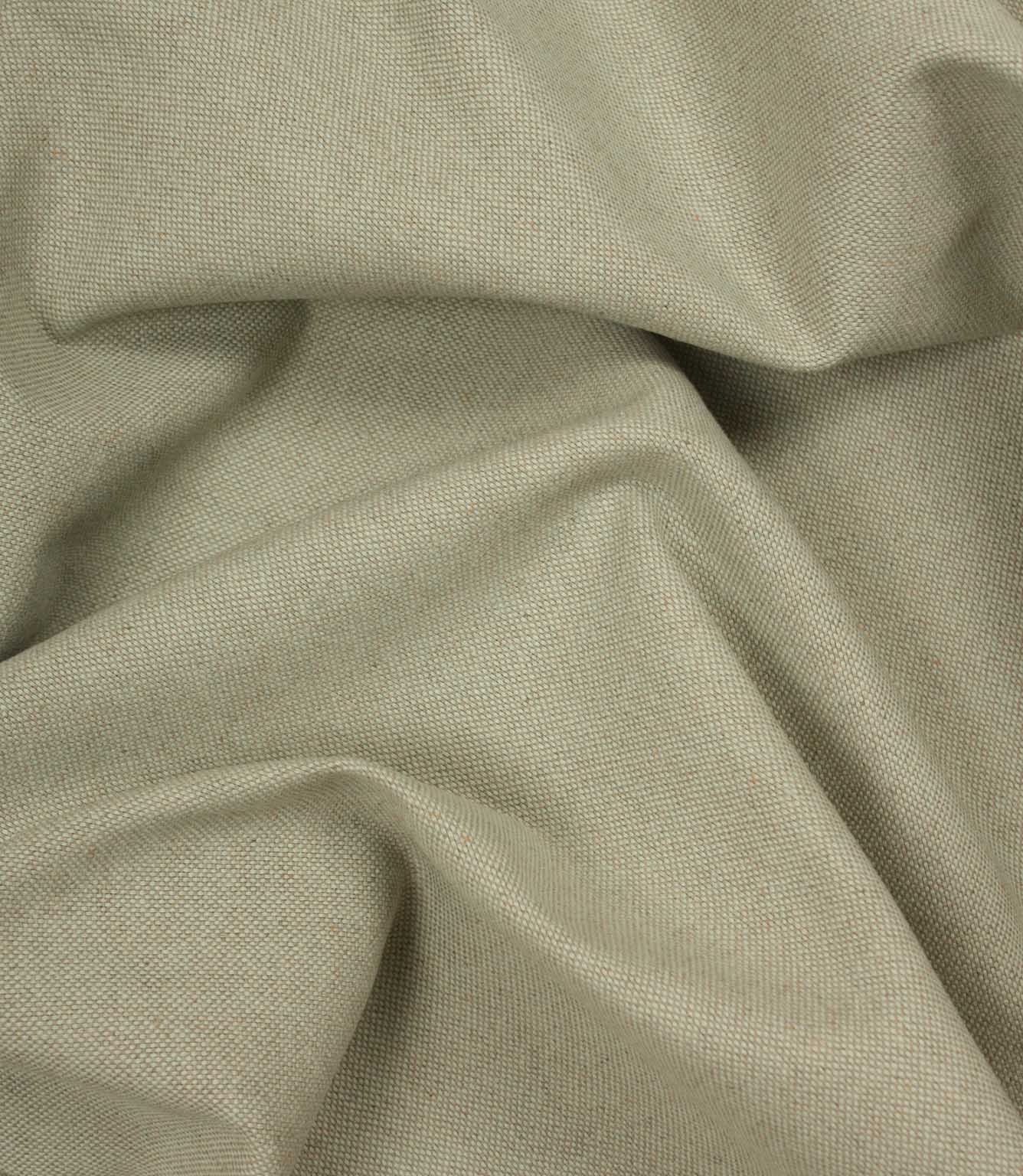 Close-up of beige woven fabric with folds