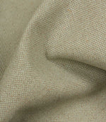 Close-up of textured beige fabric with a subtle pattern