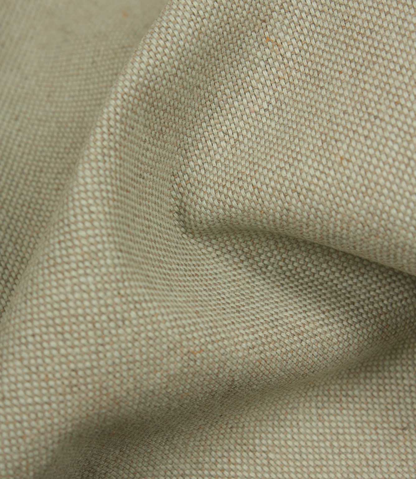 Close-up of textured beige fabric with a subtle pattern