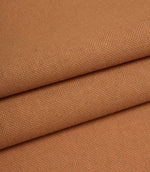 Close-up of orange woven fabric with a textured pattern