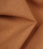 Close-up of orange woven fabric with a textured pattern