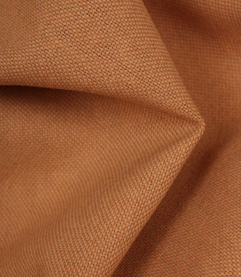 Close-up of orange woven fabric with a textured pattern