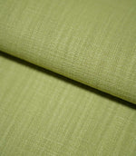 Close-up of Waverley Celery fabric gently folded, revealing its fine basket-like weave, textured surface and muted green colour.
